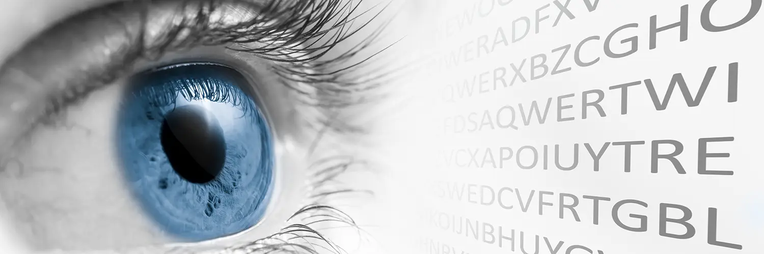bright blue eye looking at eye chart letters