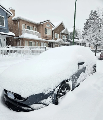 tons of snow on car